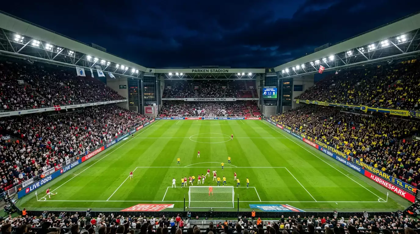 Europæisk fodboldstadion fyldt med tilskuere under aftenkamp
